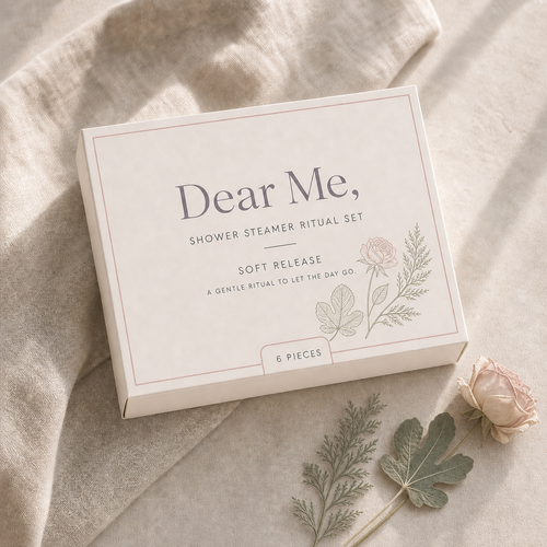 A quiet luxury product hero image showing the SOFT RELEASE six-piece shower steamer gift set in Dear Me, packaging with cedar, fig and rose-inspired botanical details.