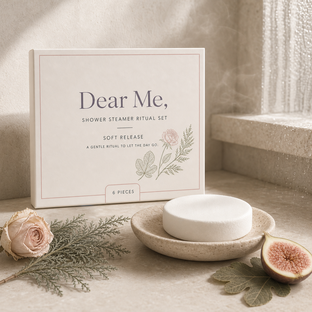 A calm bathroom ritual scene showing an unwrapped shower steamer in use with visible steam, styled with rose, cedar and fig details to express the soft release ritual.